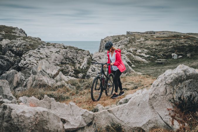 Female bicyclist on rocks
