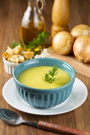 Bowl with onion soup and croutons on the table.