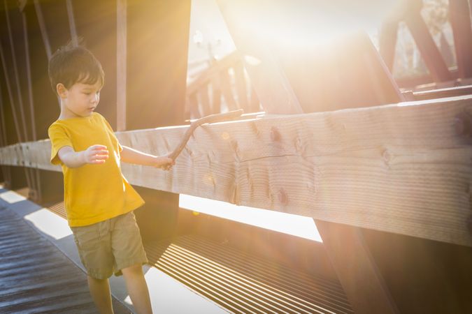 Biracial Boy Walking on Bridge