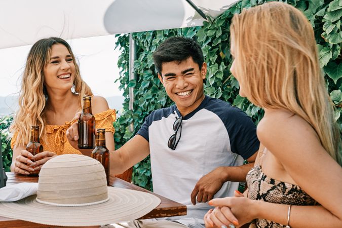 a group of young people cheering with beer in summer
