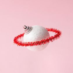 Christmas bauble with red ring on pink background