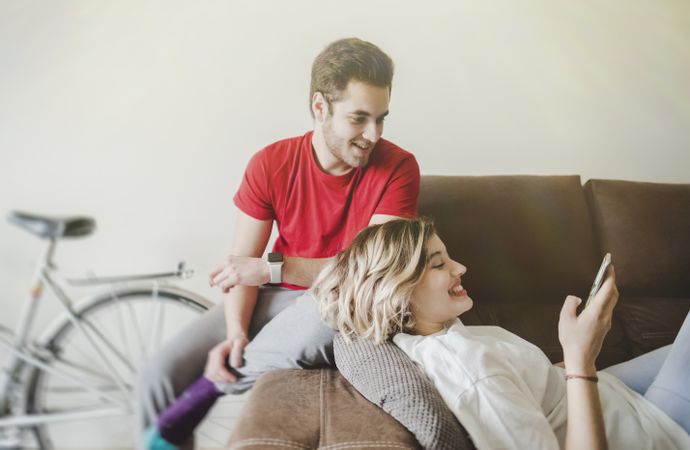 Couple on sofa on the mobile phone