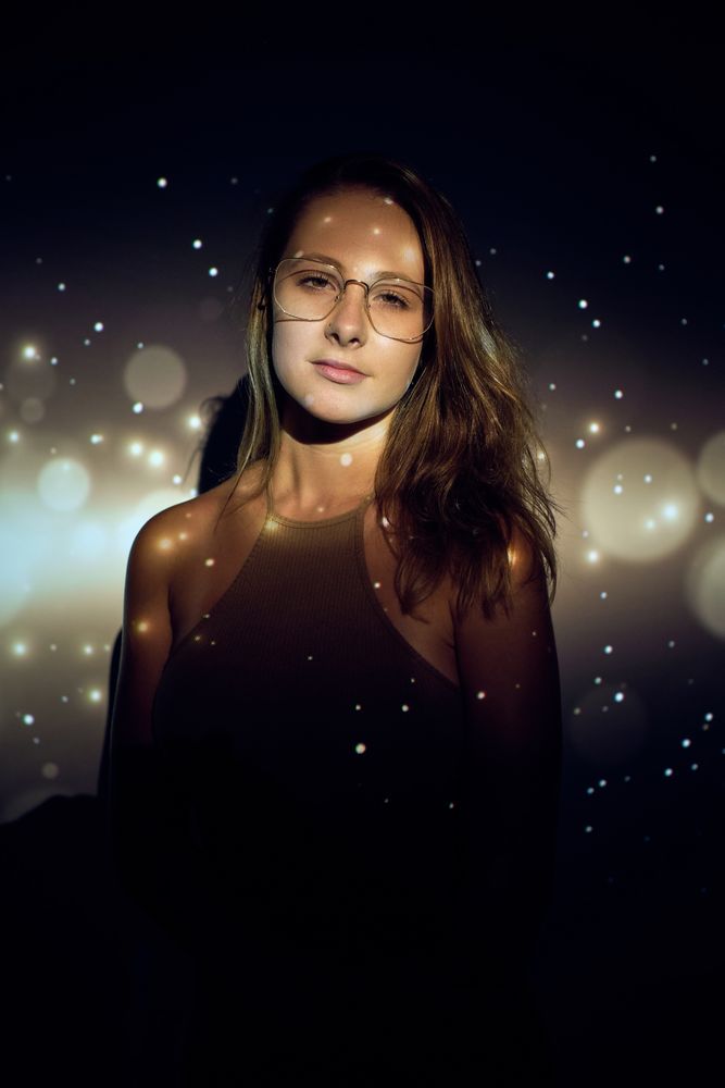 Indifferent woman under sparks projection