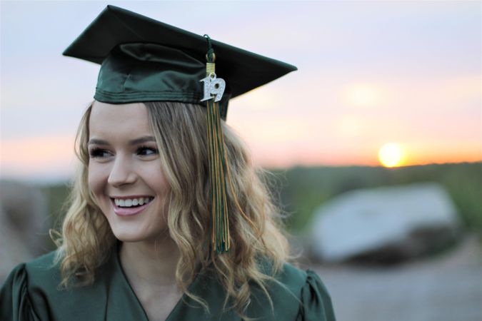 Woman smiling wearing graduation gown