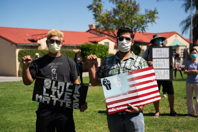 Los Angeles, CA, USA — June 7th, 2020: two young men stand at a protest against police brutality