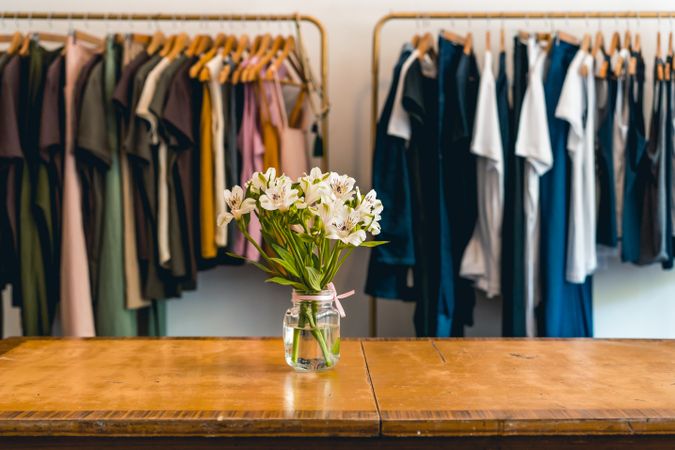 Clothes hanging on a rack in a showroom. Copy space