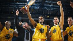 Multiethnic Basketball Players Celebrate Championship Victory with Hugs, Jumping, Holding the Trophy.