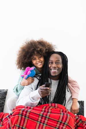 Cheerful Black dad and daughter enjoying free time together