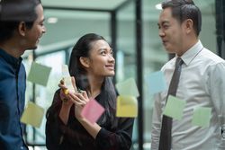 Business colleagues brainstorming with sticky notes in office