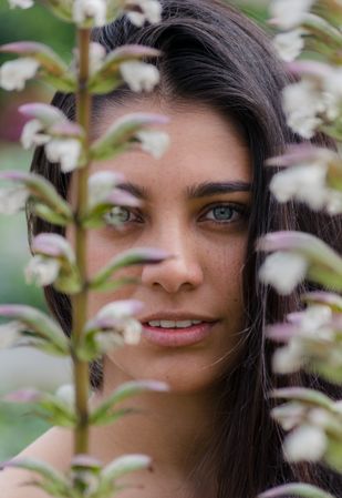 Young charming woman between flowers