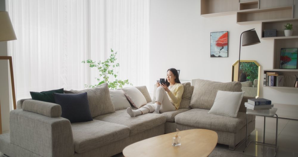 Portrait of a Korean Female Using Smartphone and Holding a Credit Card.
