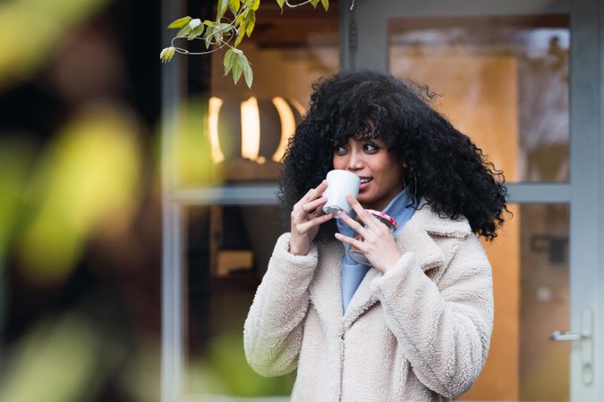 Smiling Black woman with cup of coffee