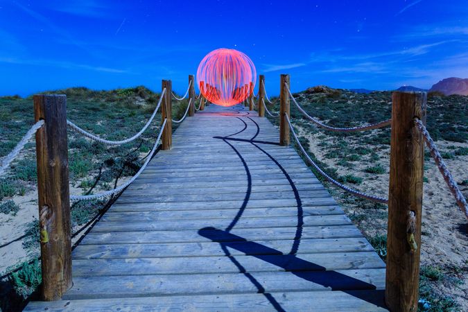 Abstract ball on footbridge between lands