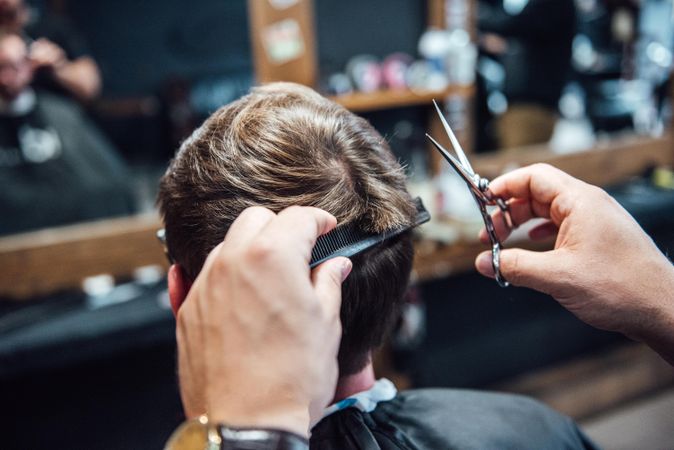 Barber cutting customer's hair