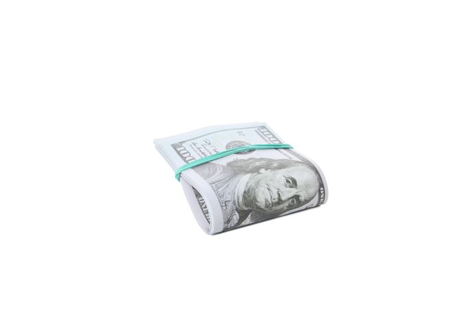 Stacks of American cash money, isolated on light background