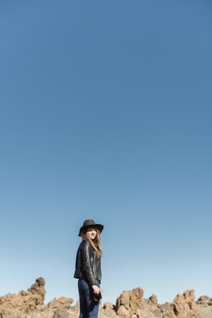 Woman with camera in desert