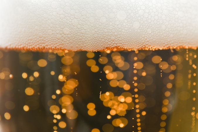 Beer and foam texture on whole background, close up