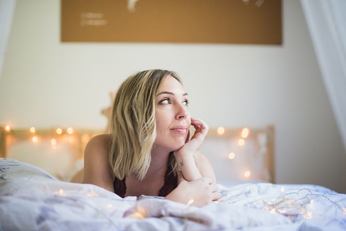 Woman lying in bed at home