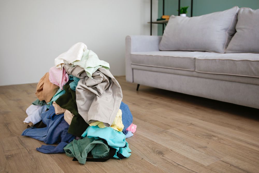 Pile of carelessly scattered clothes on floor.