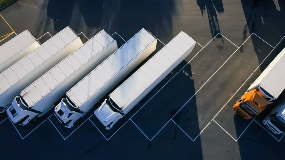 Aerial Shot of Trucks Are Unloading Merchandise.