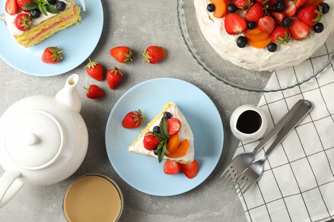Composition with delicious berry cream cake on gray background. Tasty dessert
