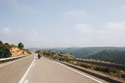 Motorcyclist riding on a cloudy summers day