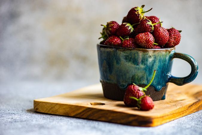Delicious strawberries in blue mug