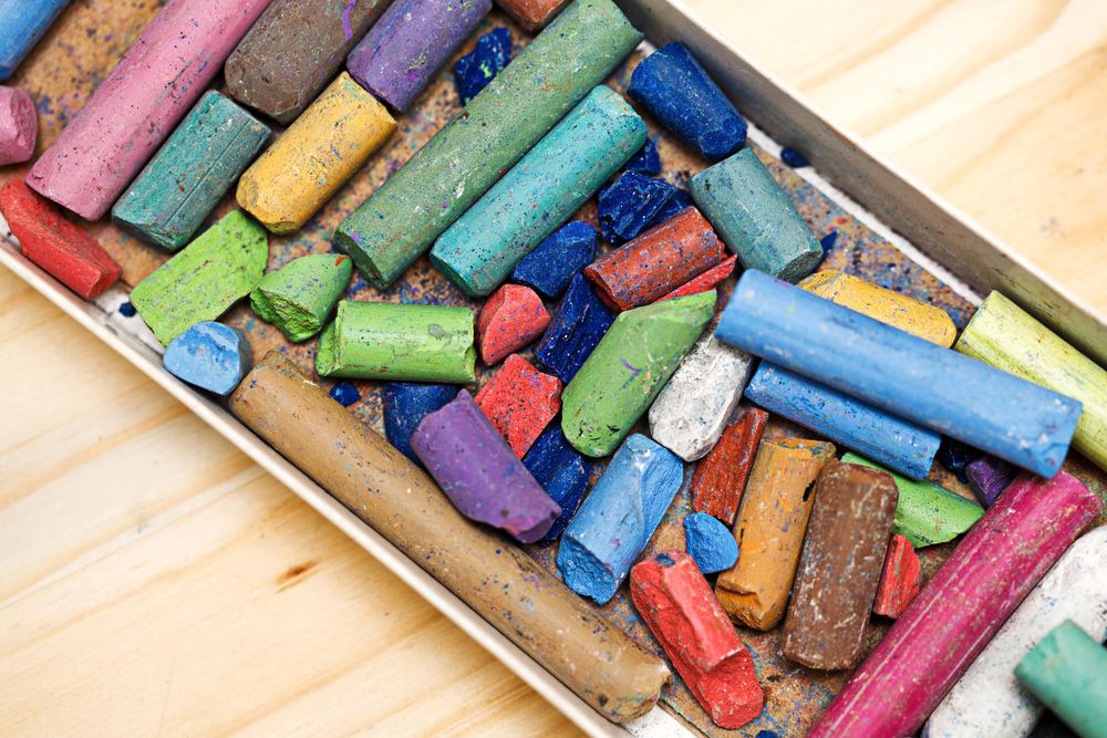 Top view of dry pastel crayons in the box