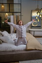 Excited boy singing in bedroom
