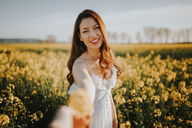 Woman with flowers in field
