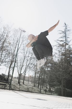 Young man in air dancing break dance in park