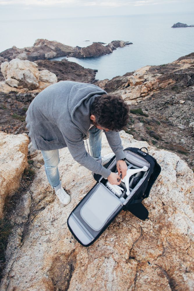 Man with backpack with photography equipment