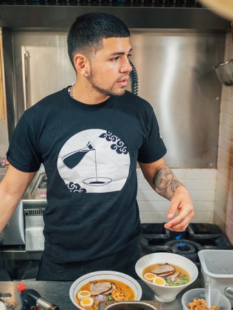 Asian chef with served bowls of ramen