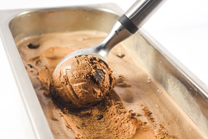 Scooping out a ball of chocolate chip ice cream