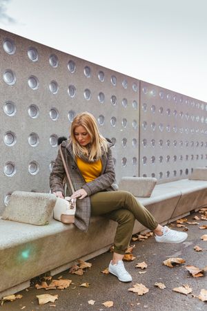Portrait of blond woman looking in her bag