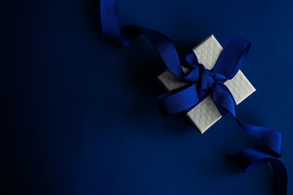 Top view of blue Valentine present on blue table