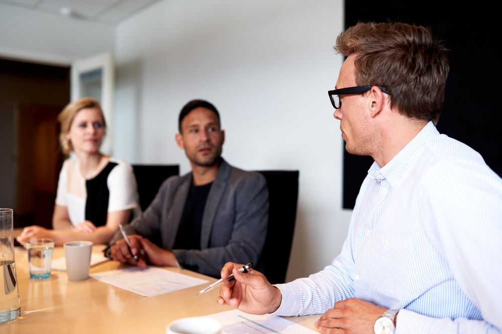 Business associates discussing work in the boardroom
