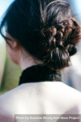 Close up shot of woman’s hair bun and her back 49mya4
