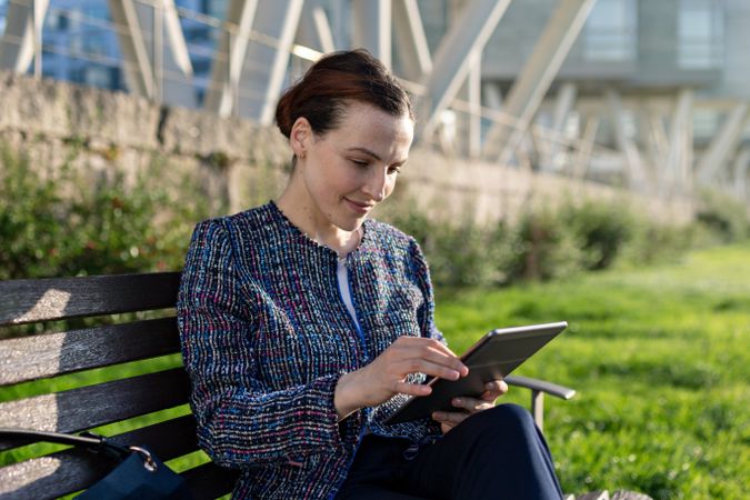Businesswoman browsing tablet in park