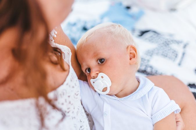 Blond baby with pacifier