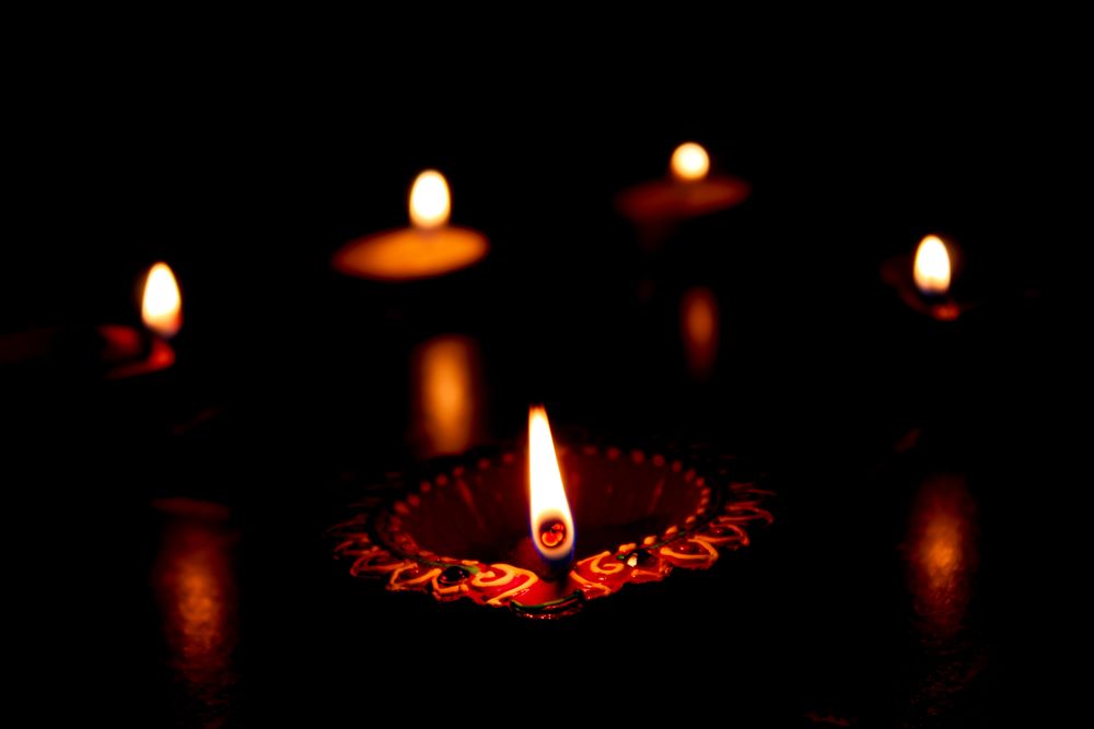 Lit diyas in dark room