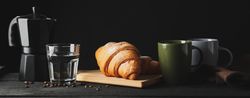 Banner with croissants on wooden breadboard, with space for text
