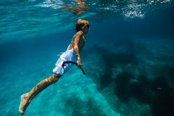 Boy in diving mask swimming underwater