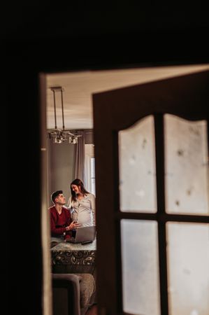 Tender couple expecting baby at home