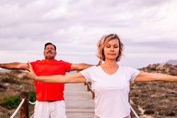 Couple practicing martial arts on lumber path