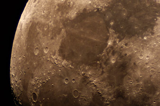 Detailed lunar surface close-up showing prominent craters and maria