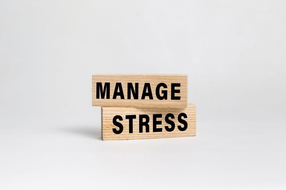 manage stress words text on wooden blocks