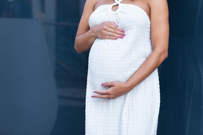 Anonymous pregnant woman in long dress