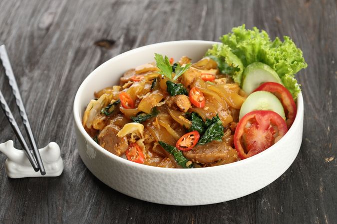 Close Up Kwetiaw Goreng, Fried Rice Flat Noodles with Chicken, Meatballs, and Vegetables.