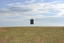 Suitcase suspended in air